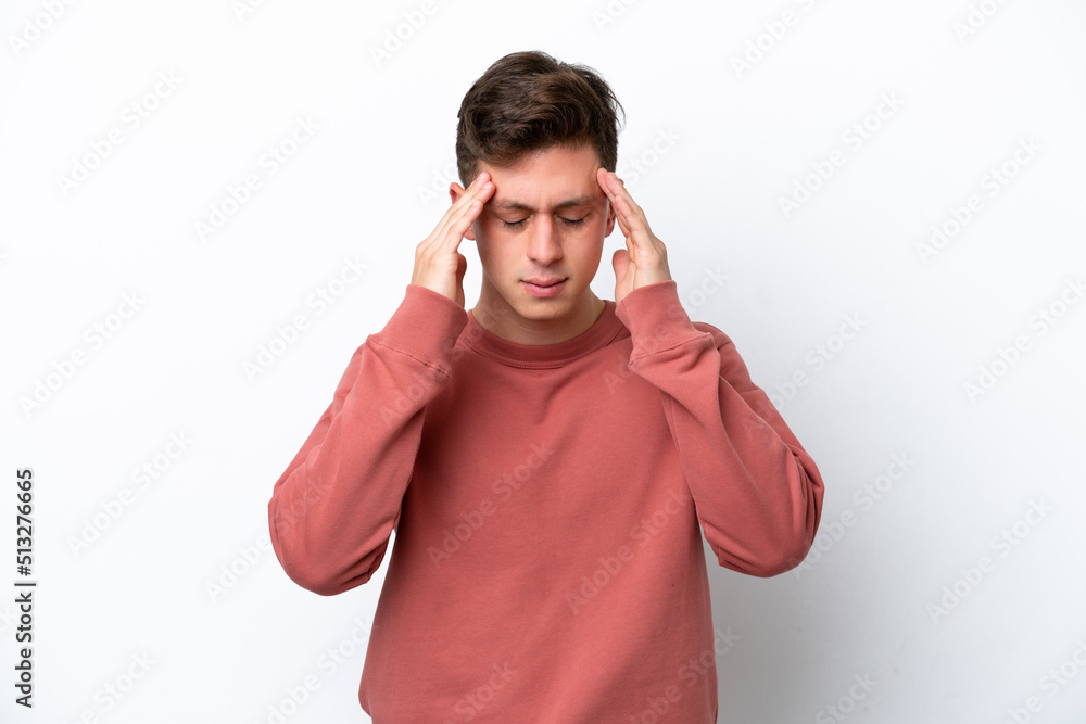 Naklejka premium Young handsome Brazilian man isolated on white background with headache