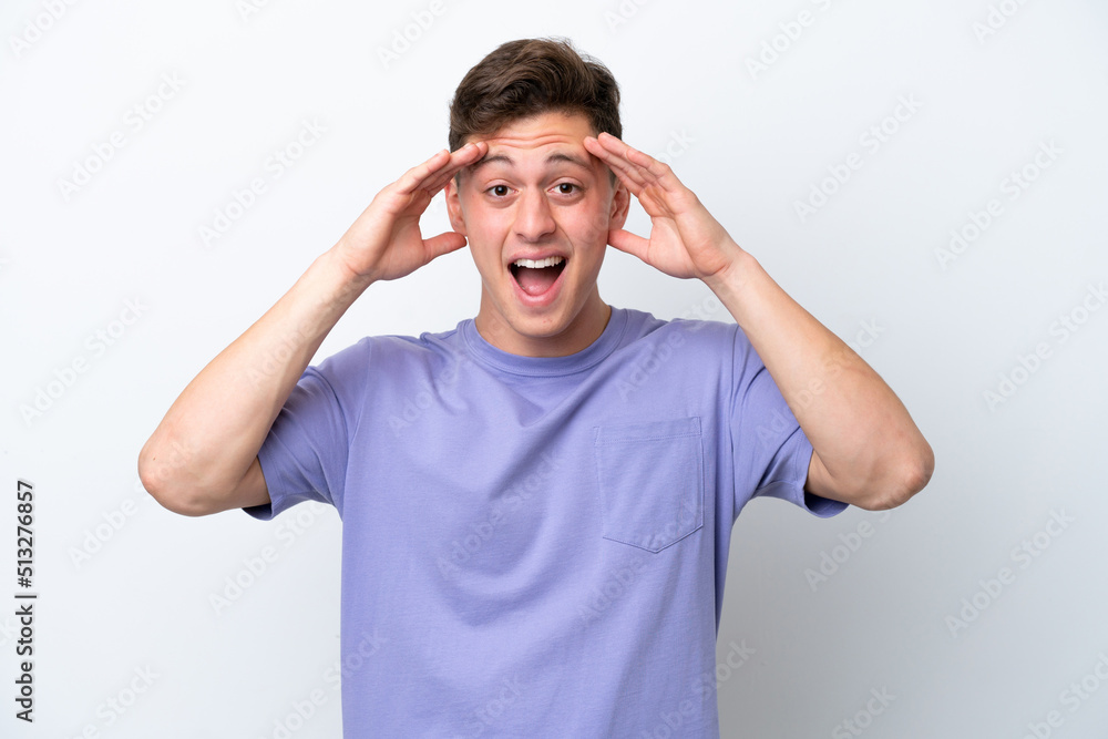 Young handsome Brazilian man isolated on white background with surprise expression Young handsome Brazilian man isolated on white background with surprise expression