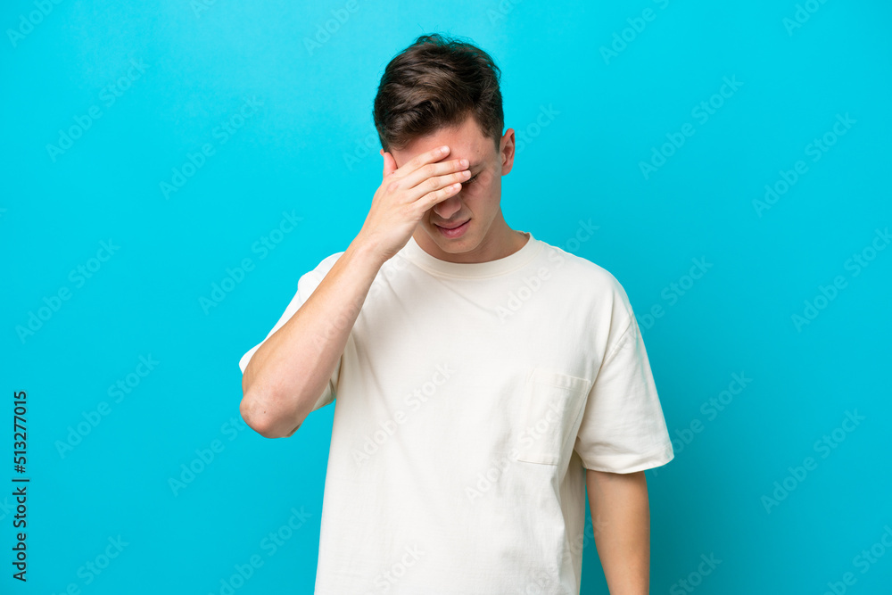 Young handsome Brazilian man isolated on blue background with headache Young handsome Brazilian man isolated on blue background with headache