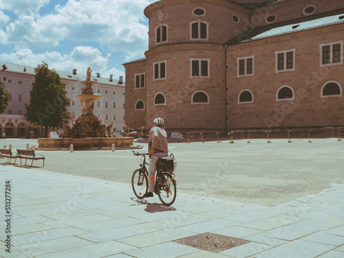 man riding a bicycle in the city of salzburg, Austria