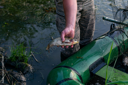 The fisherman swam to the shore on a boat and shows his catch. Overfishing damages the local fishing industry. A series of pictures.