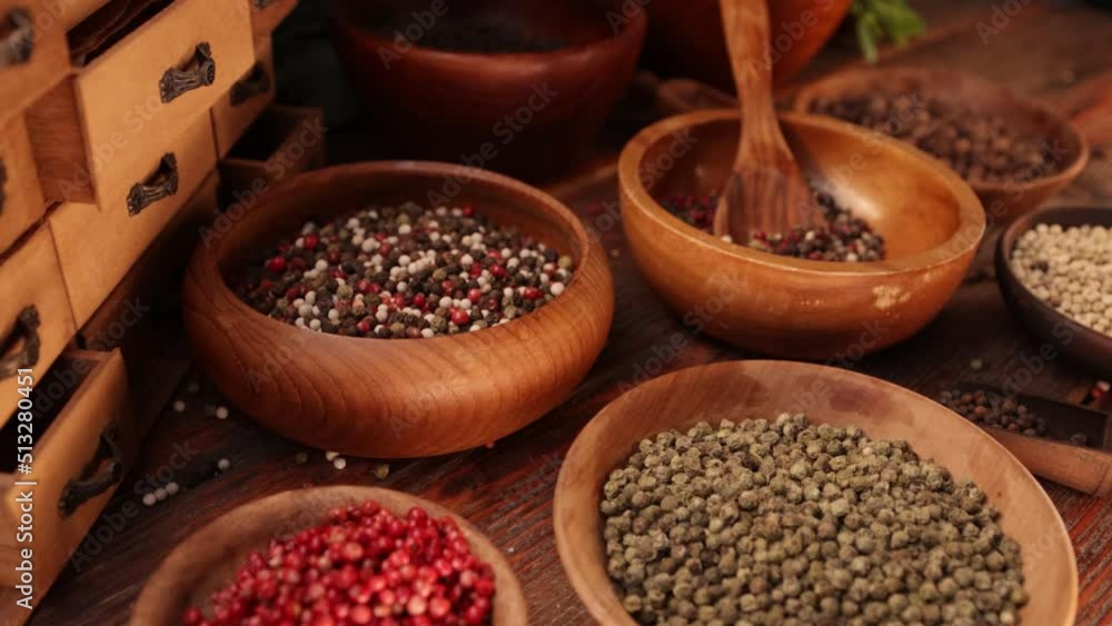 Collection of various spices and condiments in wooden bowls arranged on shabby wooden table, 4k Collection of various spices and condiments in wooden bowls arranged on shabby wooden table, 4k
