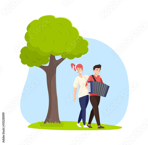 Smiling couple walking at park, man playing accordion