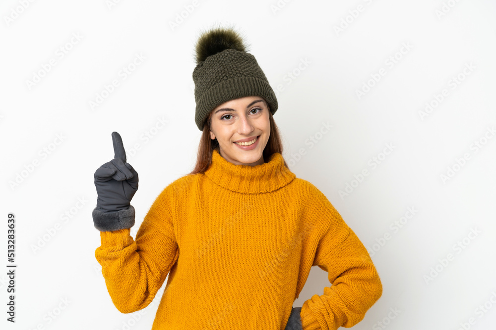 Young girl with winter hat isolated on white background showing and lifting a finger in sign of the best Young girl with winter hat isolated on white background showing and lifting a finger in sign of the best