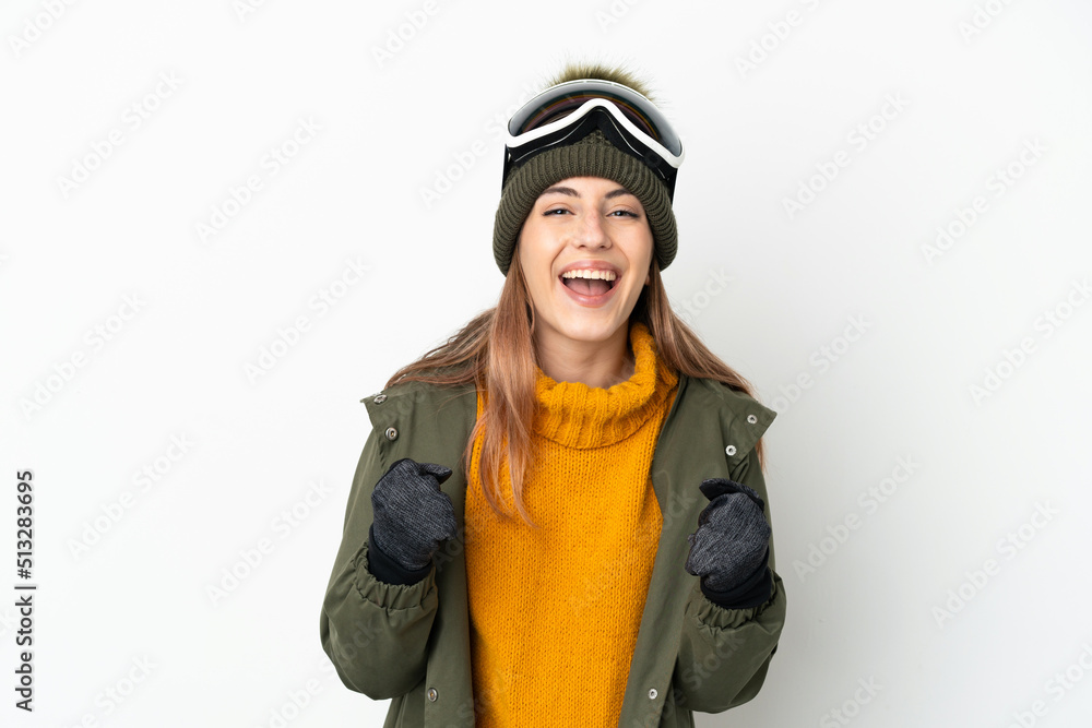 Skier caucasian woman with snowboarding glasses isolated on white background celebrating a victory in winner position Skier caucasian woman with snowboarding glasses isolated on white background celebrating a victory in winner position