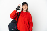Young sport woman with sport bag isolated on white background showing ok sign with fingers