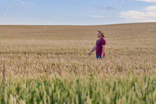 Farmer walking through a wheat field