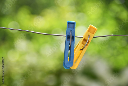 two clothespins hanging on a rope