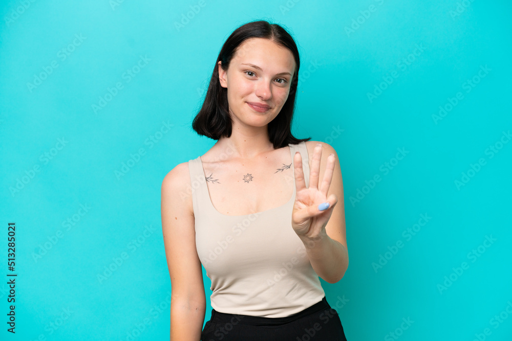 Young caucasian woman isolated on blue background happy and counting three with fingers Young caucasian woman isolated on blue background happy and counting three with fingers