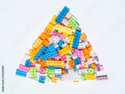 Stacked toys, colorful geometric puzzles for kids, isolated white background and copy space.