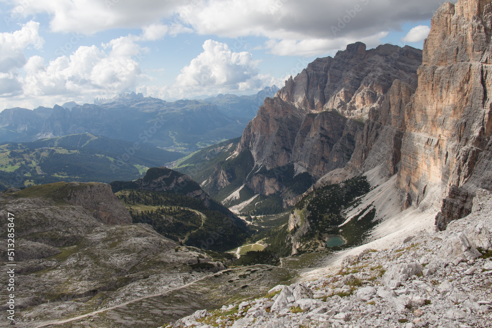 Fototapeta premium Mountain landscape with lake, valley and clouds on background, Dolomites, Italian Alps.