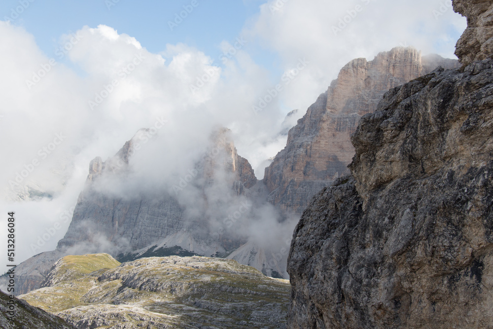 Mountain peaks seeing through clouds in a sunny day, Dolomites, Italian Alps. Mountain peaks seeing through clouds in a sunny day, Dolomites, Italian Alps.