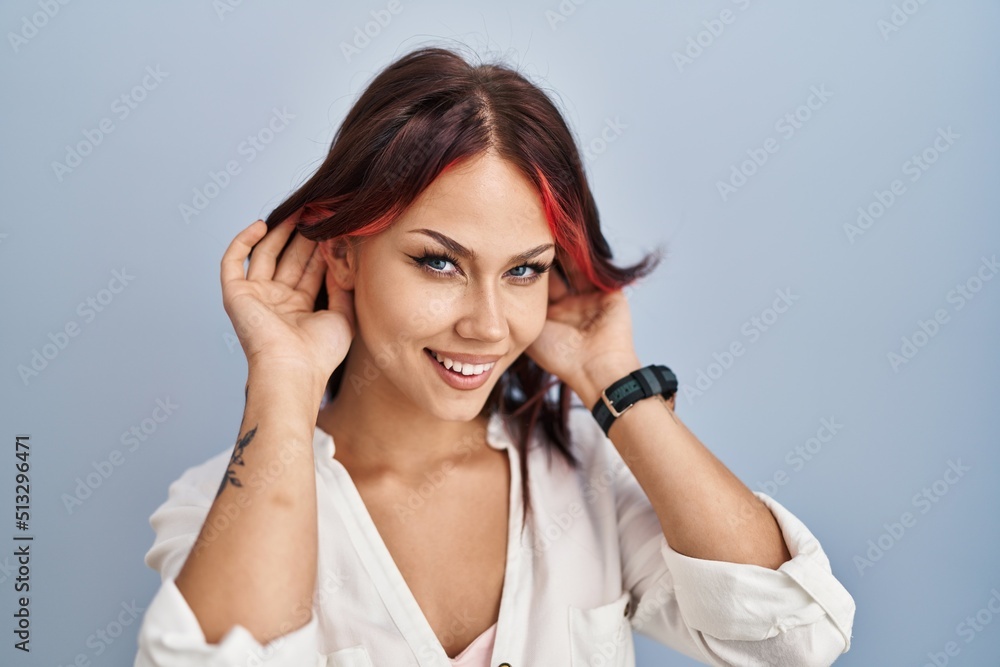 Young caucasian woman wearing casual white shirt over isolated background trying to hear both hands on ear gesture, curious for gossip. hearing problem, deaf Young caucasian woman wearing casual white shirt over isolated background trying to hear both hands on ear gesture, curious for gossip. hearing problem, deaf