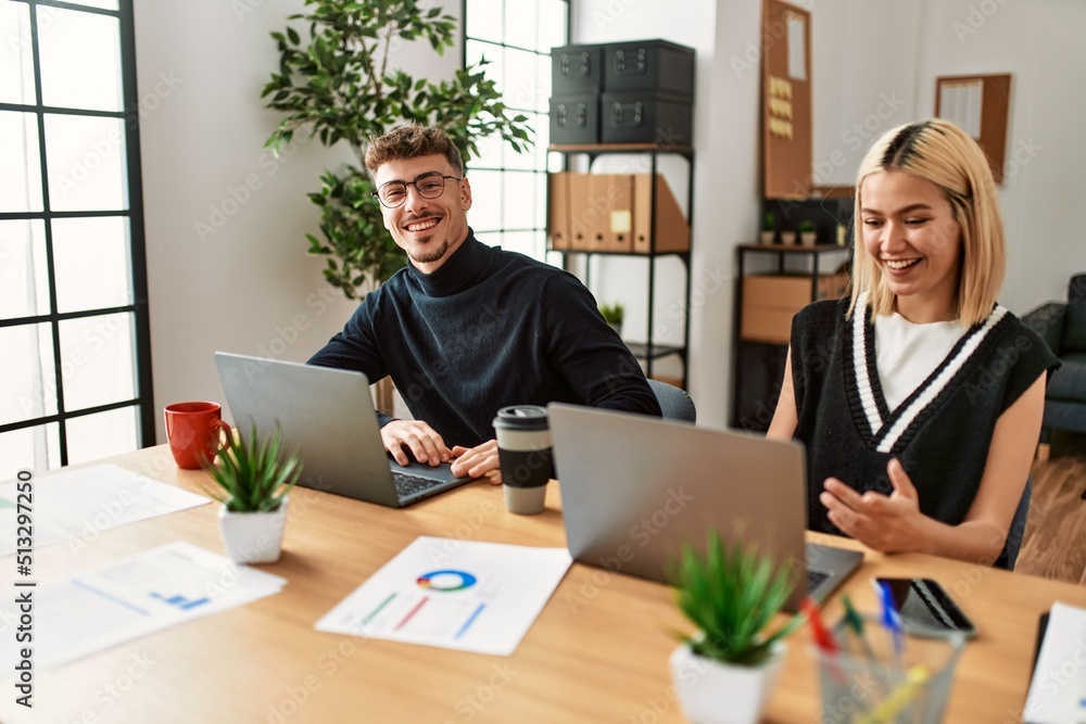 Two business workers smiling happy having video call at the office.