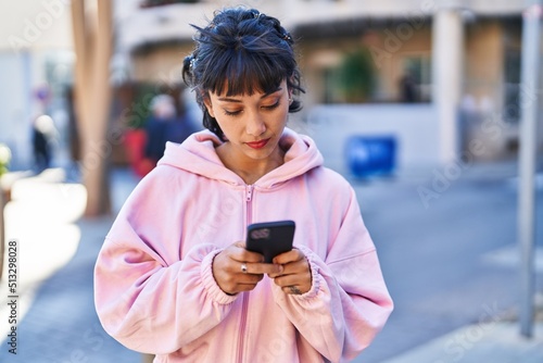 Young woman using smartphone at street