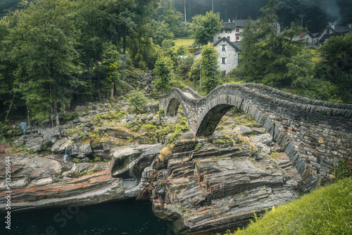 View on the Lavertezzo village, famous tourist destination - An old Swiss village with double arch stone bridge at Ponte dei Salti with waterfall, Lavertezzo, Verzascatal, Canton Tessin