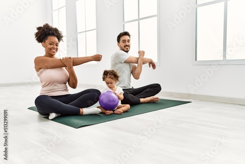 Couple and daughter smiling confident stretching at sport center