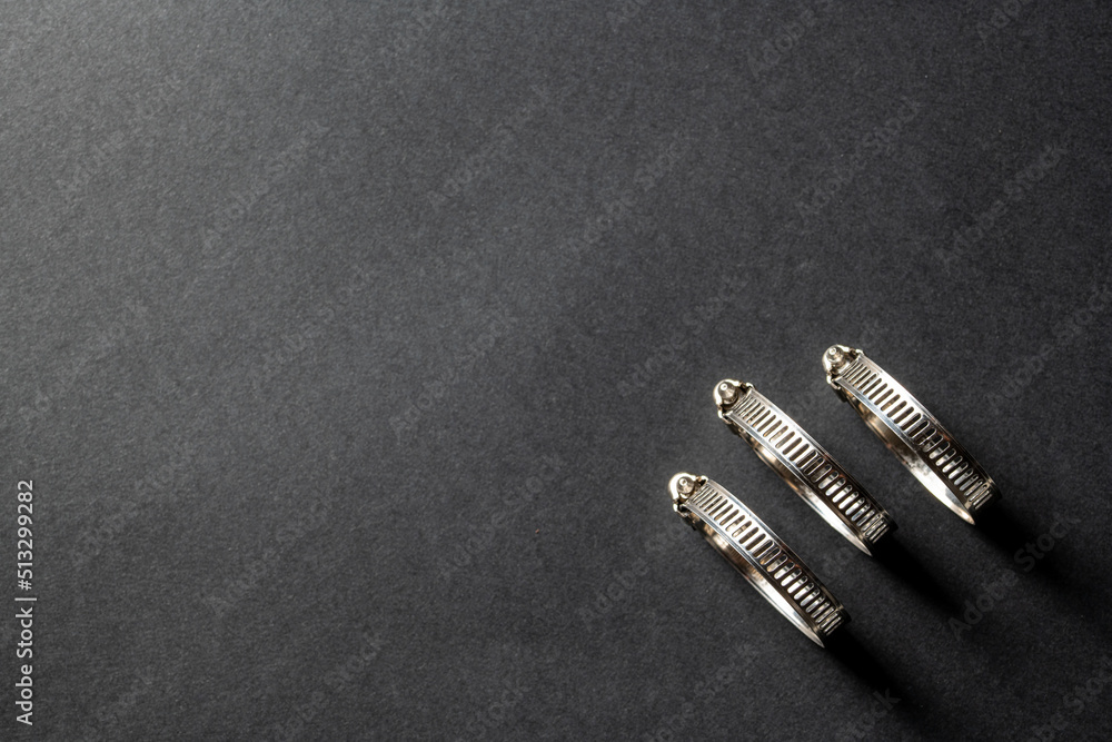 Metal hose clamp on black background. Empty space for text Metal hose clamp on black background. Empty space for text