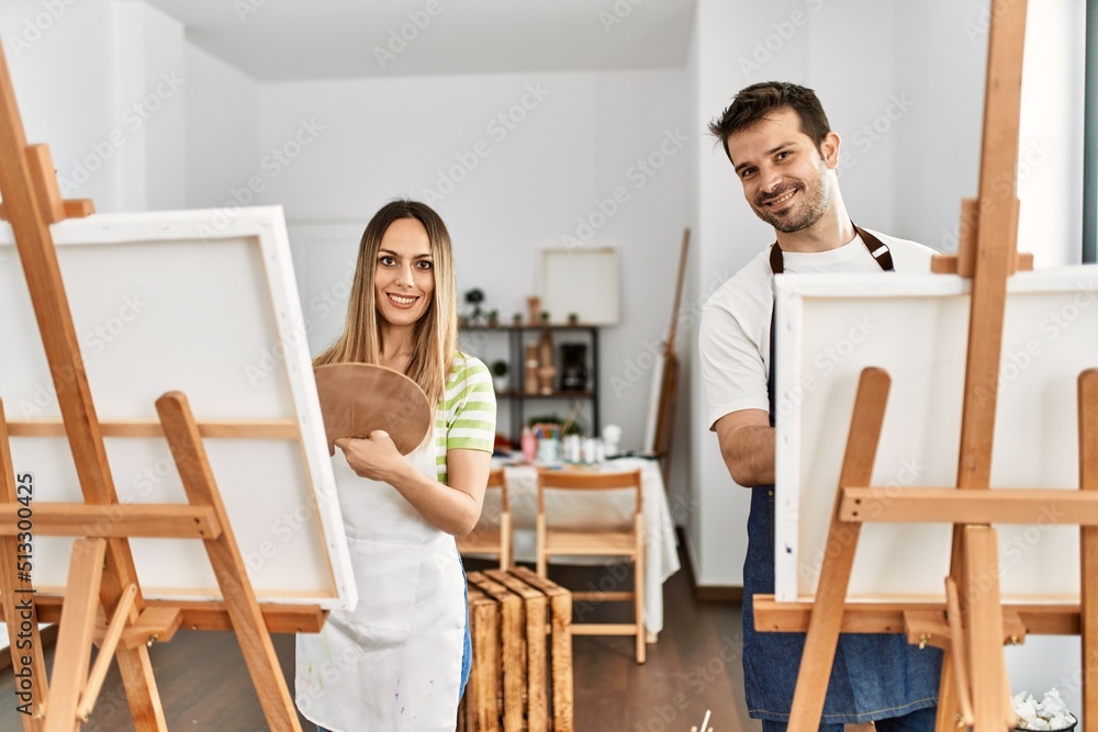 Two hispanic students smiling happy painting at art studio. Two hispanic students smiling happy painting at art studio.