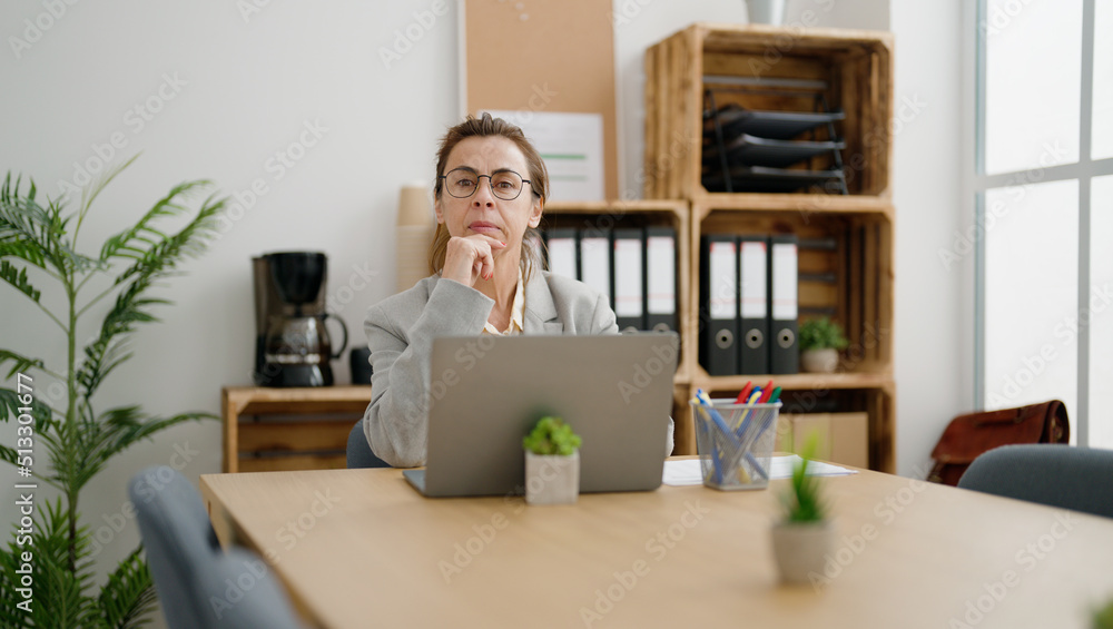Middle age hispanic woman business worker using laptop at office Middle age hispanic woman business worker using laptop at office