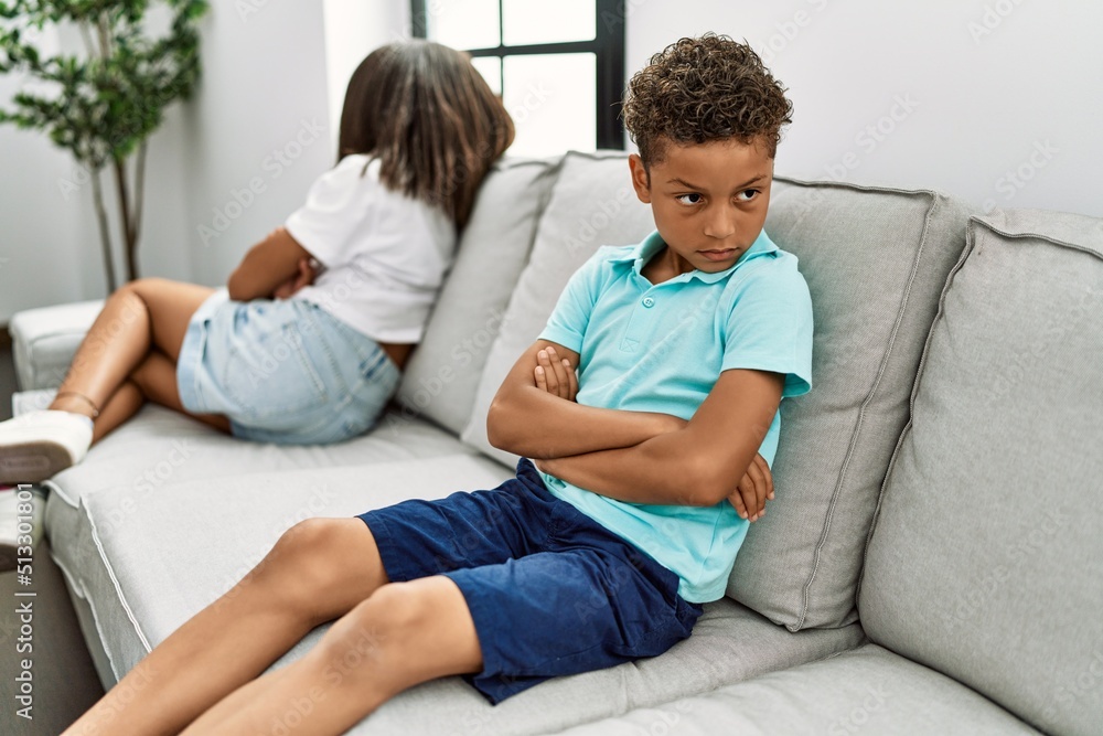 Brother and sister angry having problem sitting on sofa at home Brother and sister angry having problem sitting on sofa at home