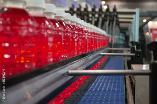 Red Soft Drink transfer on Conveyor Belt System.