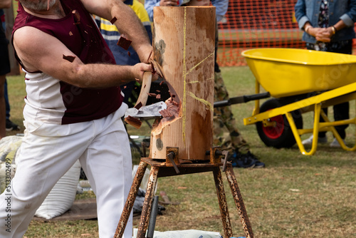 Axeman chopping a log at a small regional agricultural show at Finch Hatton.