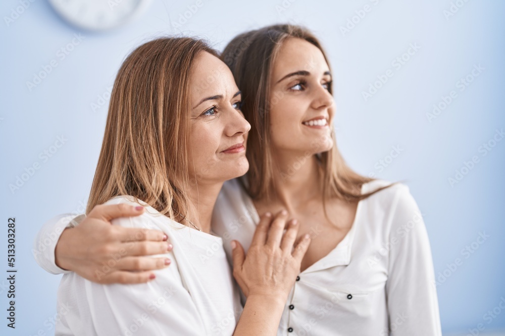 Two women mother and daughter hugging each other at home Two women mother and daughter hugging each other at home