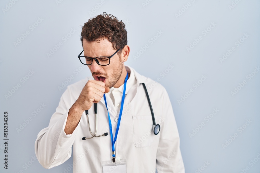 Young hispanic man wearing doctor uniform and stethoscope feeling unwell and coughing as symptom for cold or bronchitis. health care concept. Young hispanic man wearing doctor uniform and stethoscope feeling unwell and coughing as symptom for cold or bronchitis. health care concept.