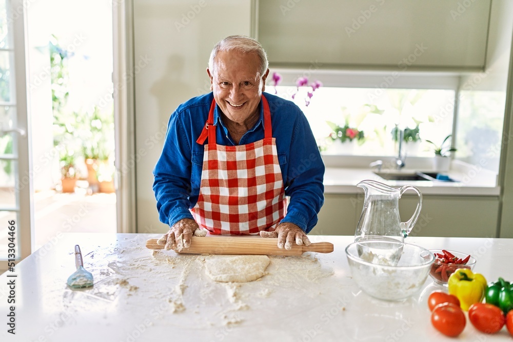 Senior man smiling confident keading dough at kitchen Senior man smiling confident keading dough at kitchen
