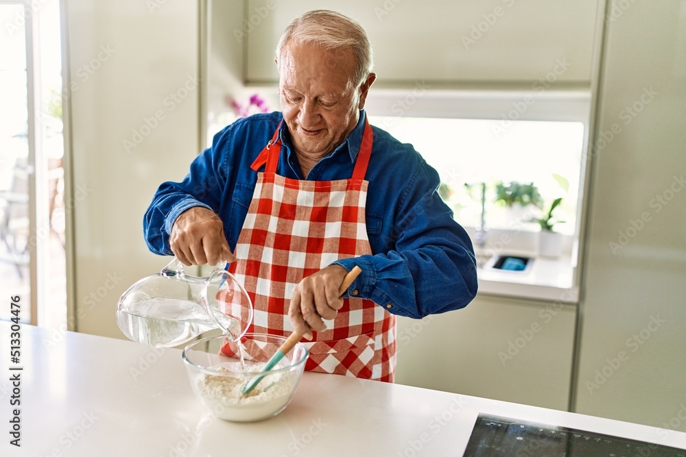 Senior man smiling confident cooking dough at kitchen Senior man smiling confident cooking dough at kitchen