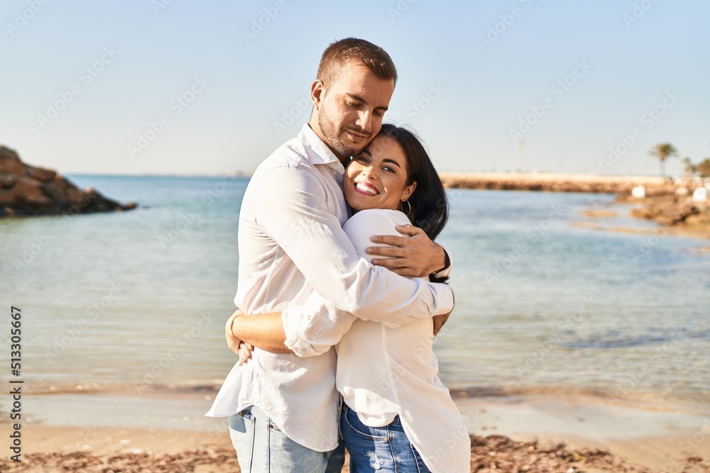 Man and woman couple smiling happy hugging each other standing at ...