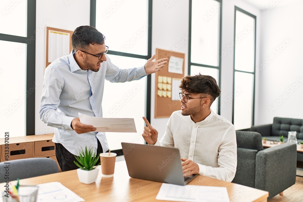 Two hispanic men business workers arguing at office Two hispanic men business workers arguing at office