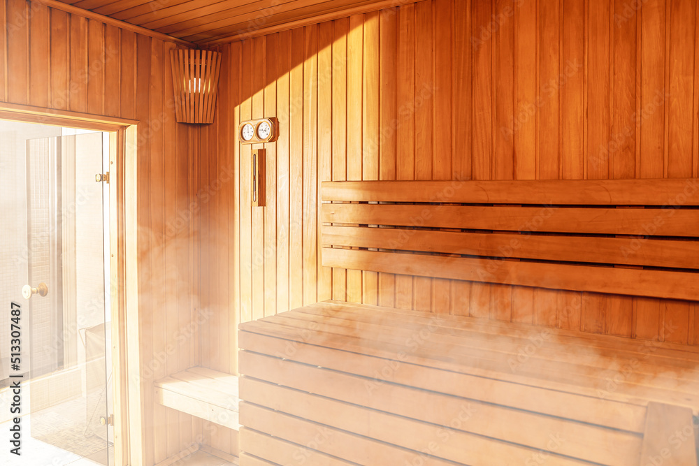 Interior of Finnish sauna, classic wooden sauna with hot steam. Russian bathroom. Relax in hot sauna with steam. Wooden interior baths, wooden benches and loungers accessories for sauna, spa complex Interior of Finnish sauna, classic wooden sauna with hot steam. Russian bathroom. Relax in hot sauna with steam. Wooden interior baths, wooden benches and loungers accessories for sauna, spa complex