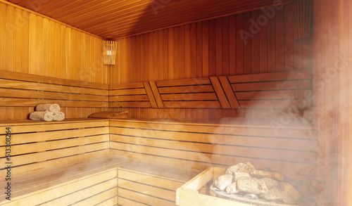 Interior of Finnish sauna, classic wooden sauna with hot steam. Russian bathroom. Relax in hot sauna with steam. Wooden interior baths, wooden benches and loungers accessories for sauna, spa complex