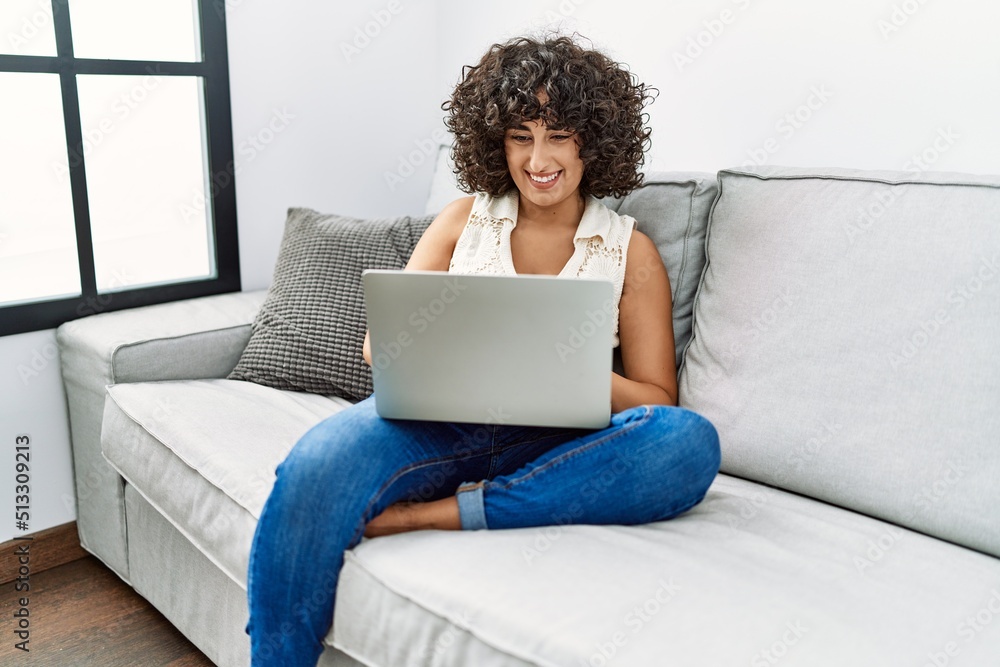 Young middle east woman smiling confident using laptop at home Young middle east woman smiling confident using laptop at home