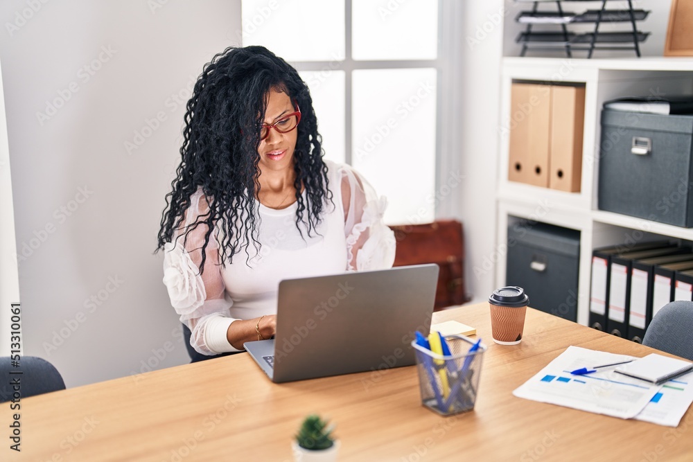 African american woman business worker using laptop working at office African american woman business worker using laptop working at office