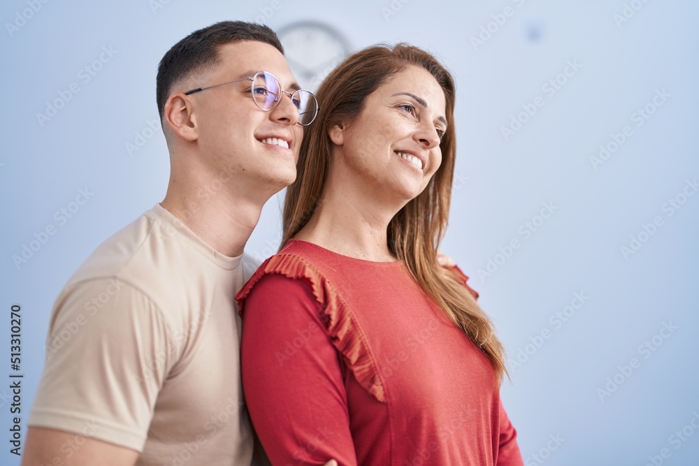 Man and woman mother and son standing together at home Man and woman mother and son standing together at home