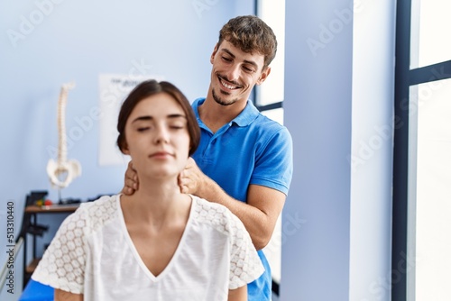 Man and woman wearing physiotherpy uniform having rehab session at clinic