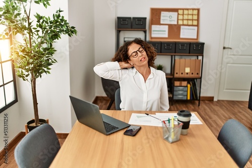 Middle age hispanic woman stretching and relaxing at office