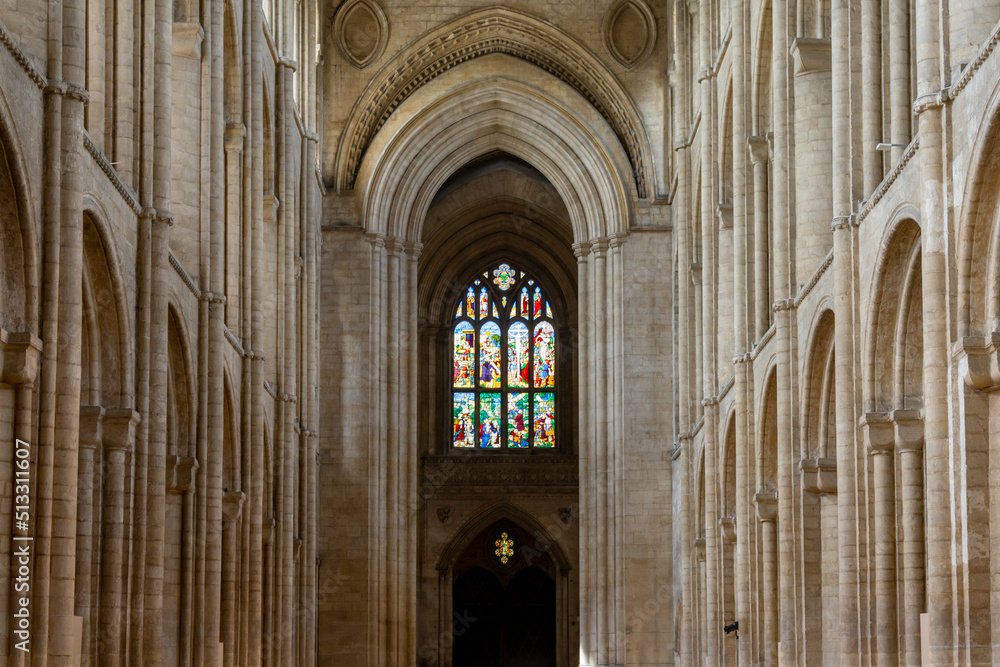 the central nave of the Ely Cathedral with its historic stained glass window
