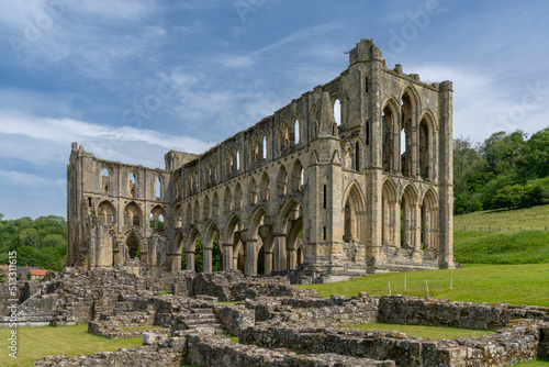 view of the historic English Heritage site and Rievaulx Abbey in North Yorkshire photo