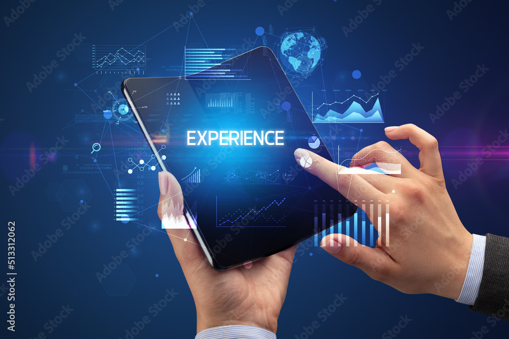 Businessman holding a foldable smartphone, business concept Businessman holding a foldable smartphone, business concept