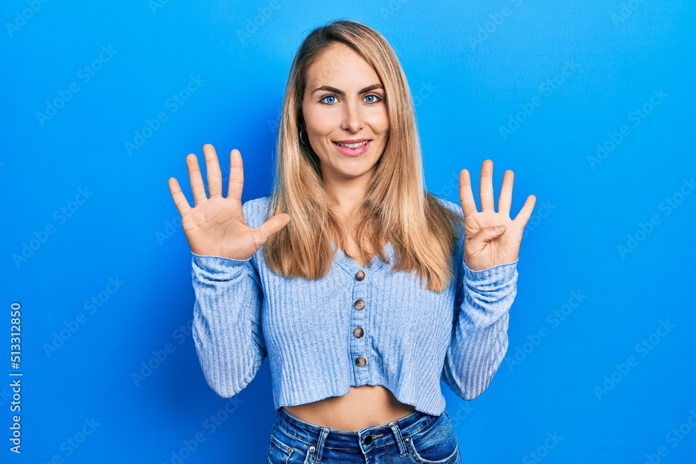 Young caucasian woman wearing casual clothes showing and pointing up with fingers number nine while smiling confident and happy. Young caucasian woman wearing casual clothes showing and pointing up with fingers number nine while smiling confident and happy.