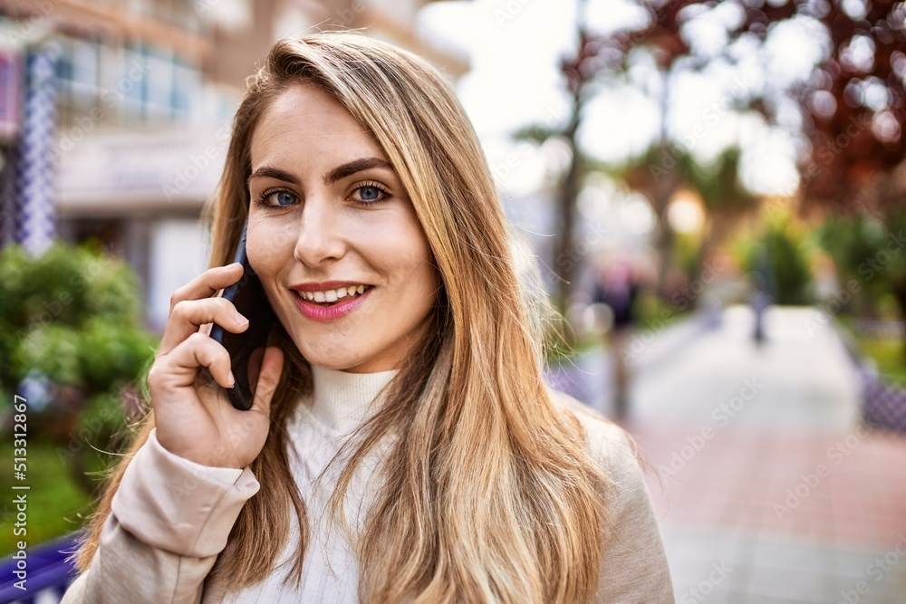 Young blonde woman smiling confident talking on the smartphone at park Young blonde woman smiling confident talking on the smartphone at park