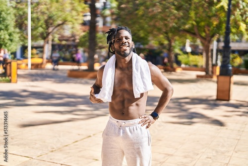 African american woman shirtless smiling confident standing at park