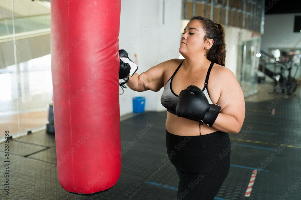 Sporty young woman learning to box