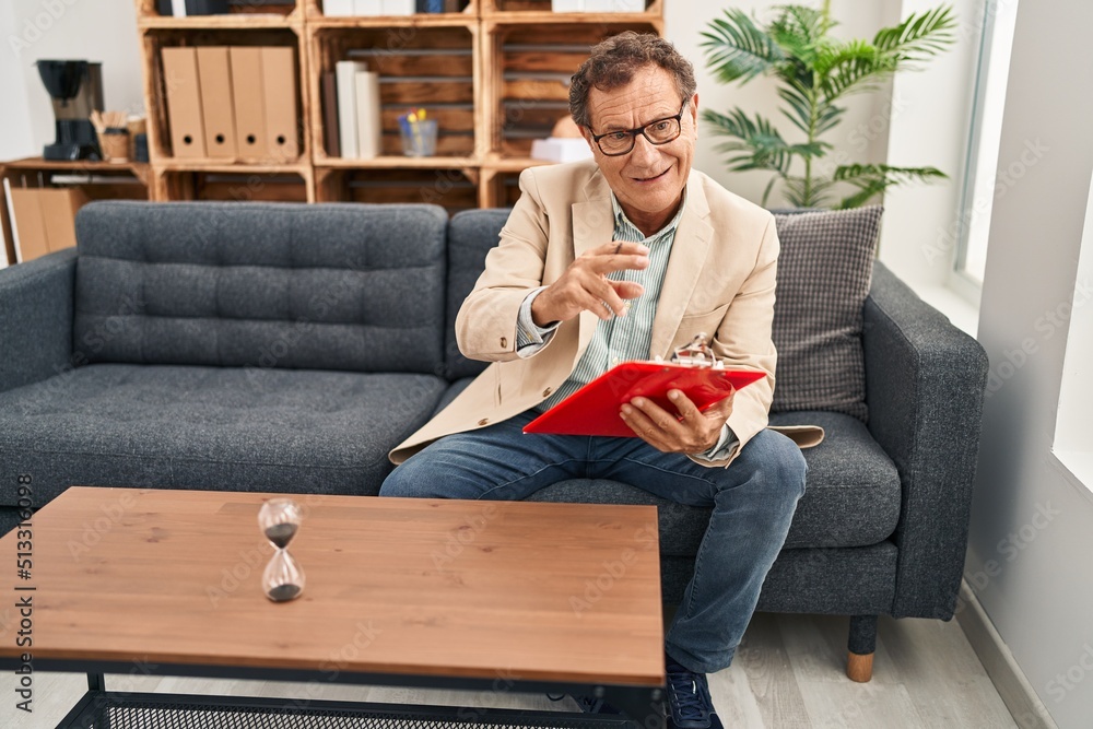 Middle age man having psychology session at clinic