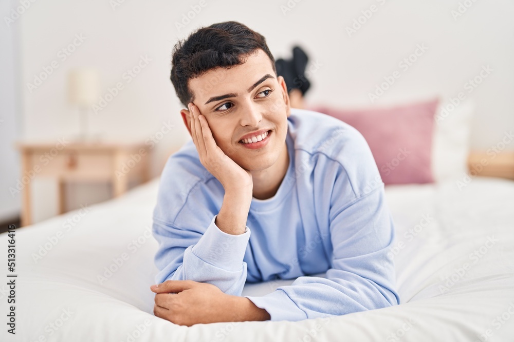 Young non binary man smiling confident lying on bed Young non binary man smiling confident lying on bed