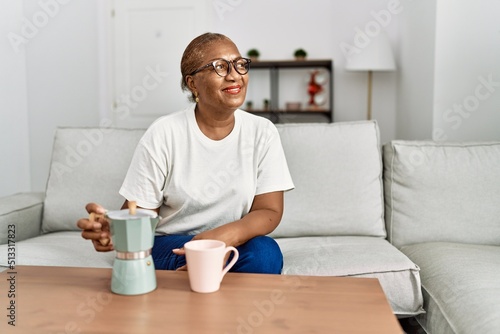 Senior african american woman smiling confident drinking coffee at home